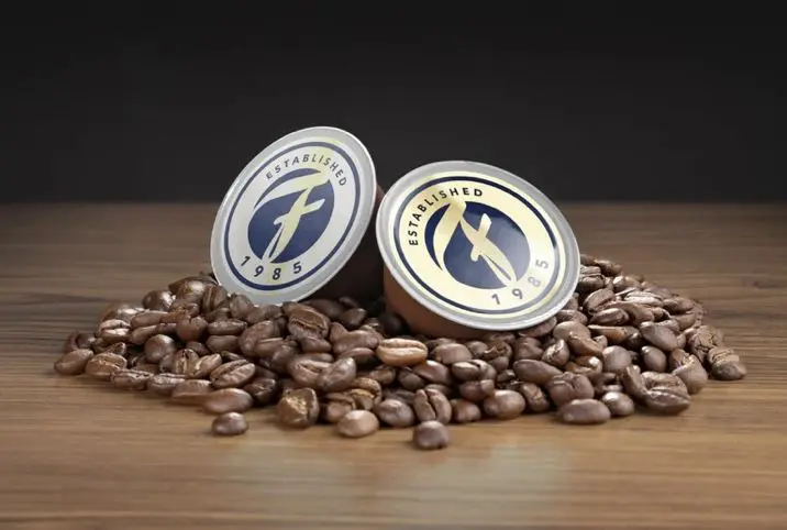 20240131_012248000_iOS Two coffee pods sitting on top of a pile of beans.
